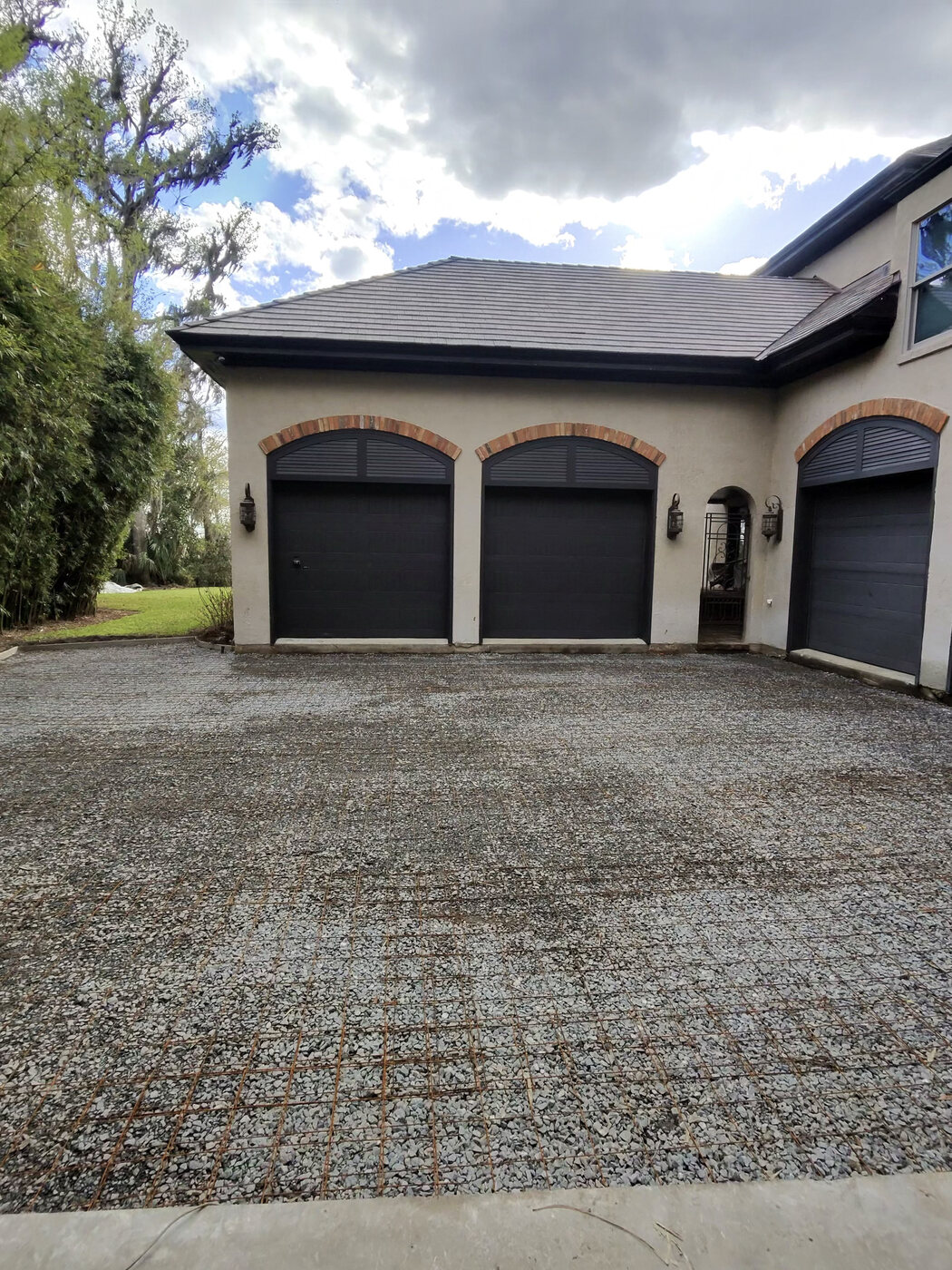 Driveway before — loose gravel