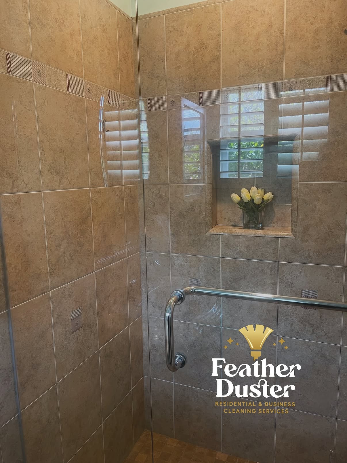 Cleaned tile shower with floral accent in the niche