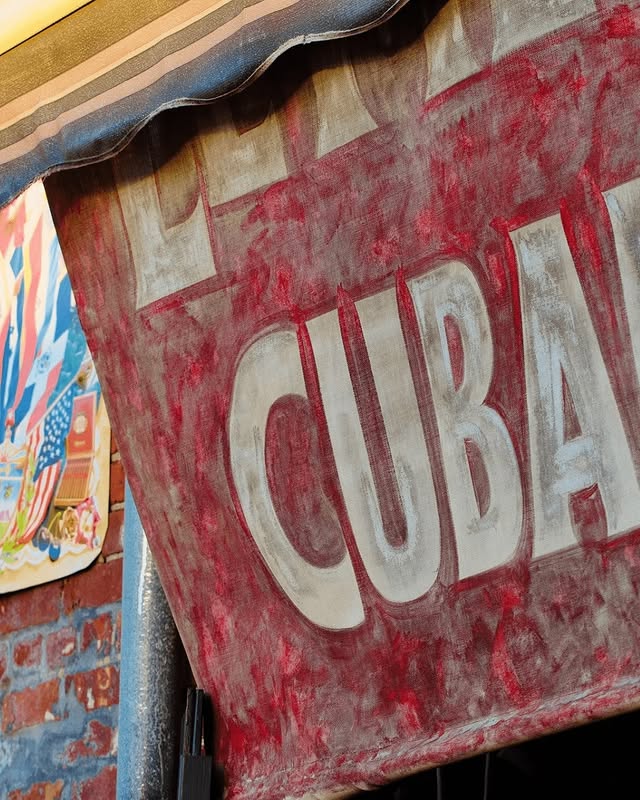 Authentic Cuban restaurant sign at El Meson de Pepe, showcasing vibrant colors and cultural heritage in Key West.