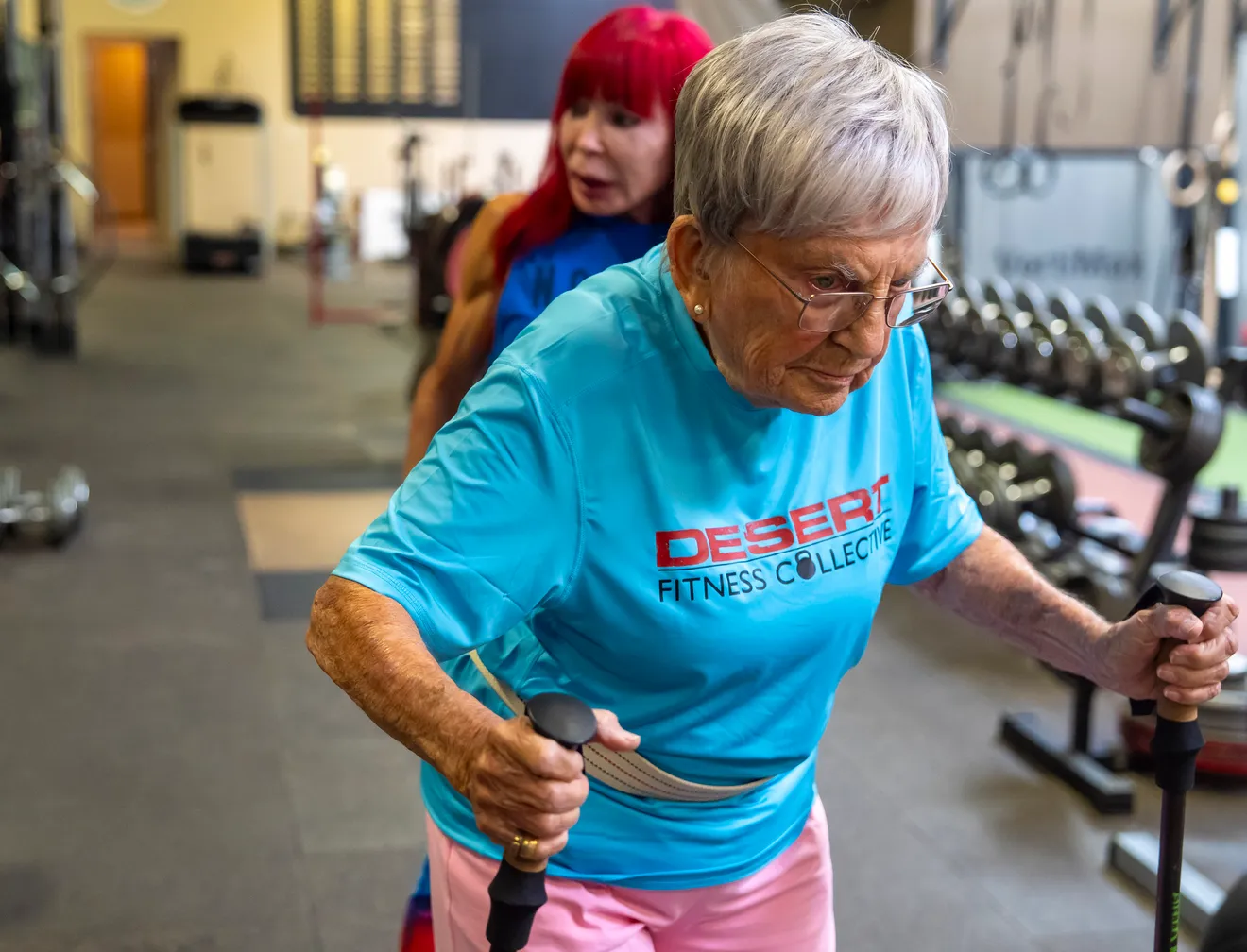 senior woman using hiking poles to walk 