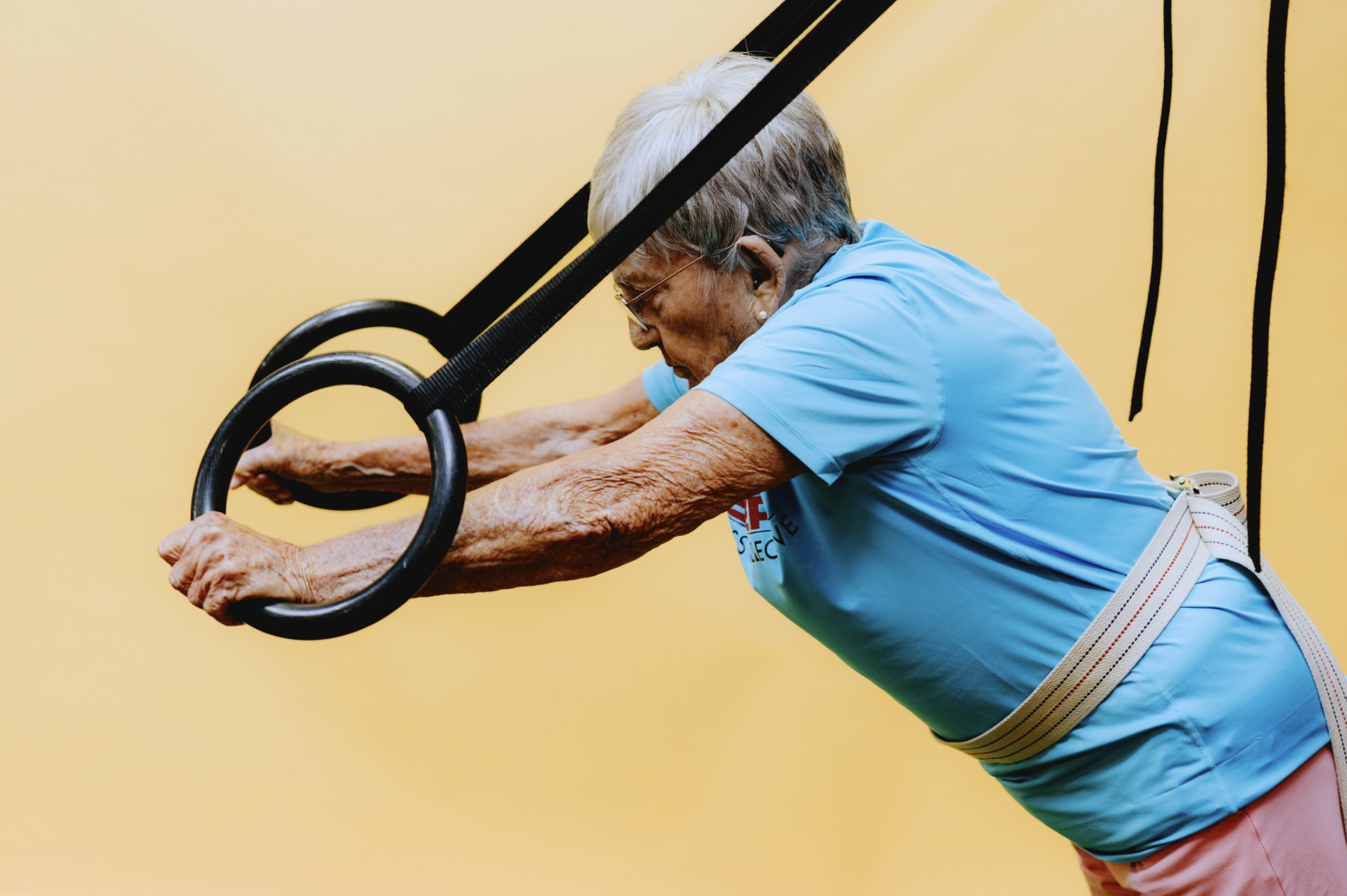 senior woman using gymnastics rings