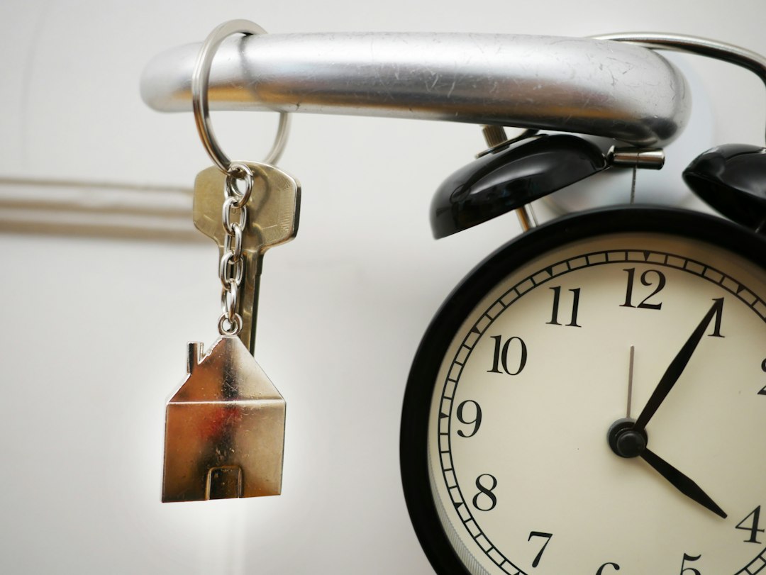 house keys and an alarm clock. representing the timing and planning of a home purchase 