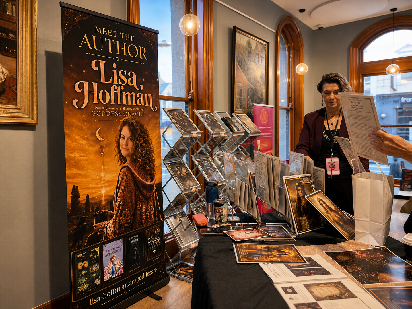 Lisa Hoffman at a market stall with Goddess readings, books and altar art