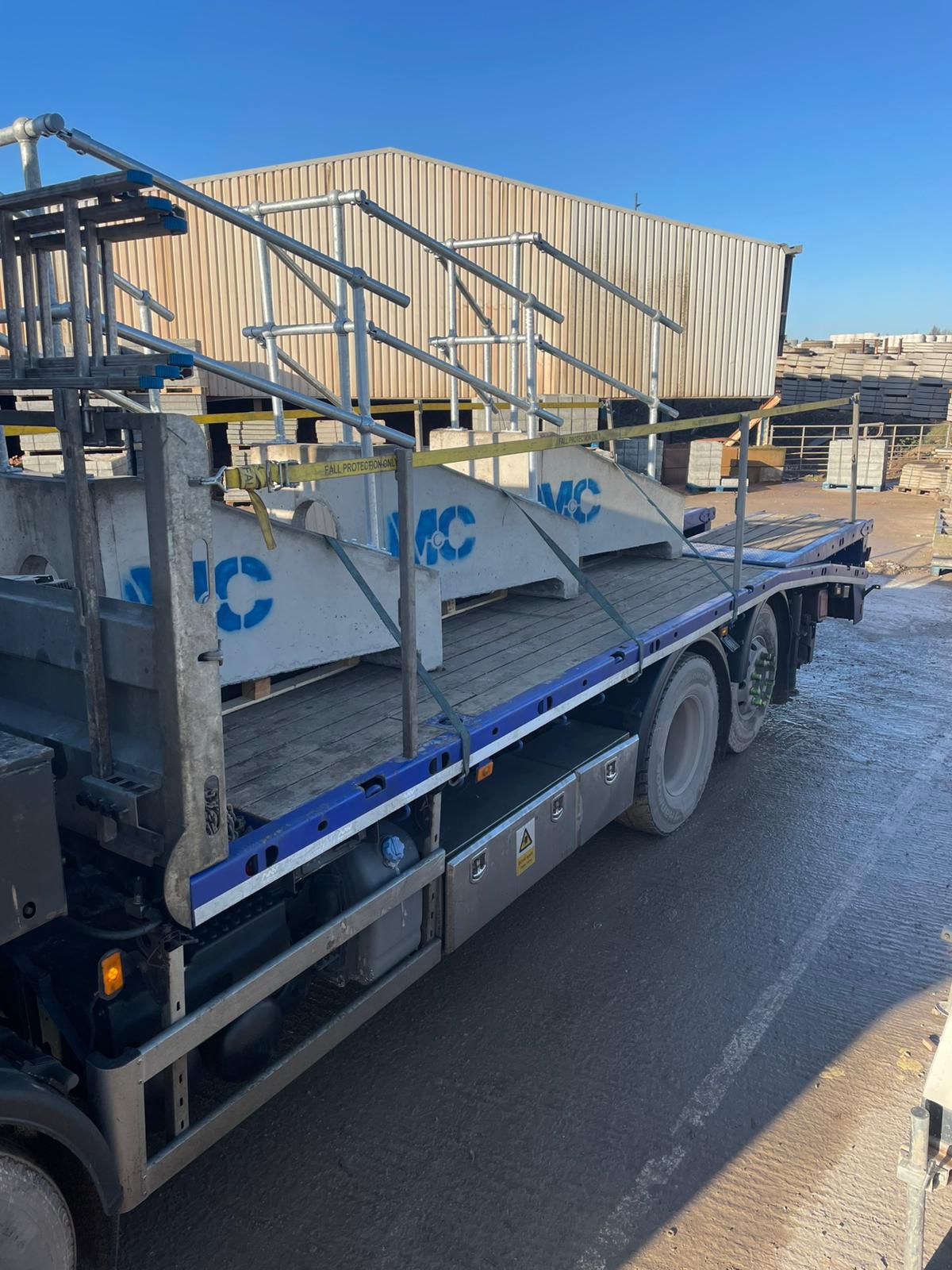 Site materials secured on flatbed for transport