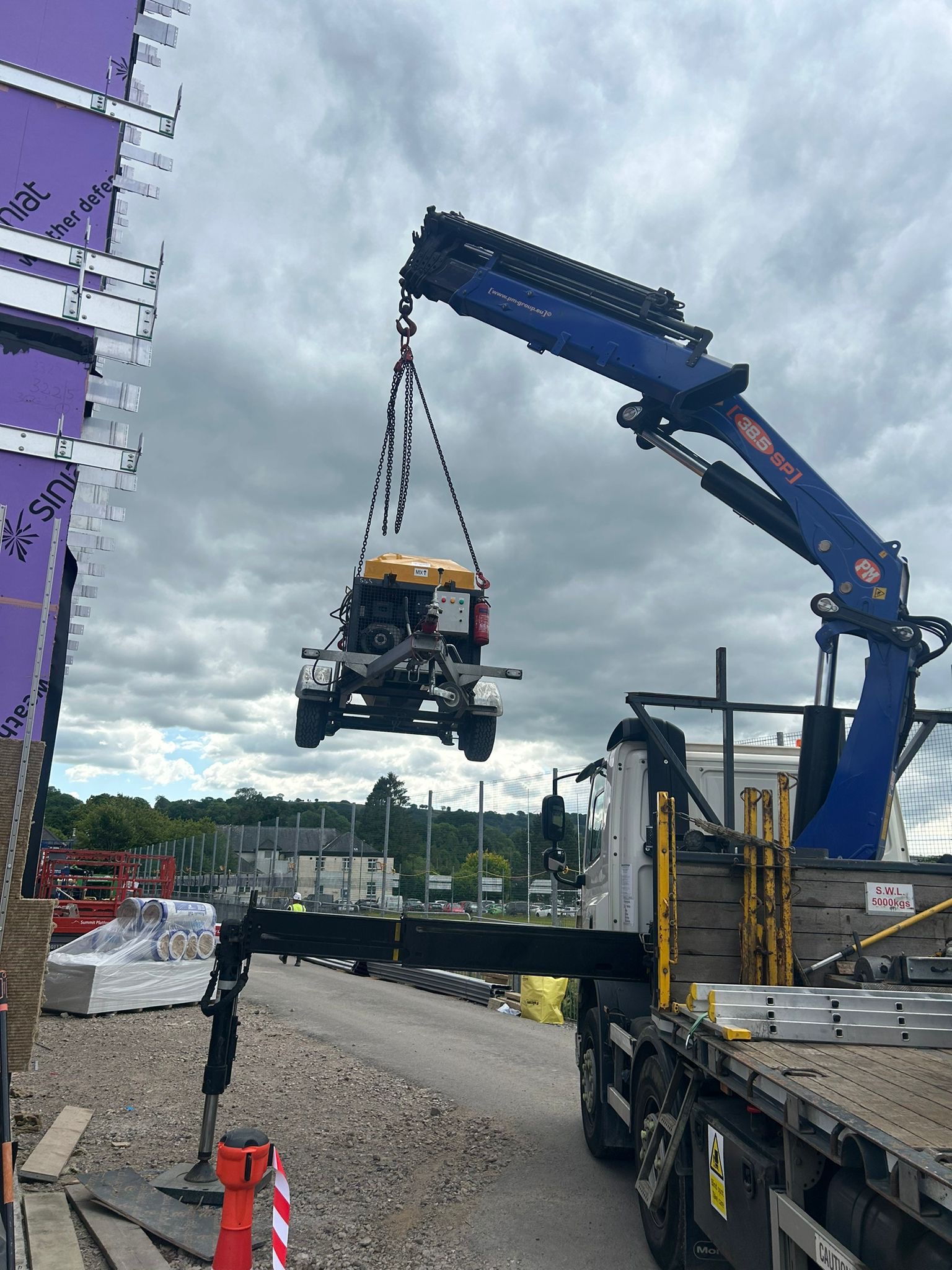 Excavator lifted by HIAB crane