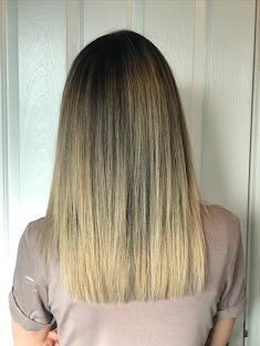 Soft balayage grow-out from dark roots to blonde ends at Bodza Beauty Hair Studio