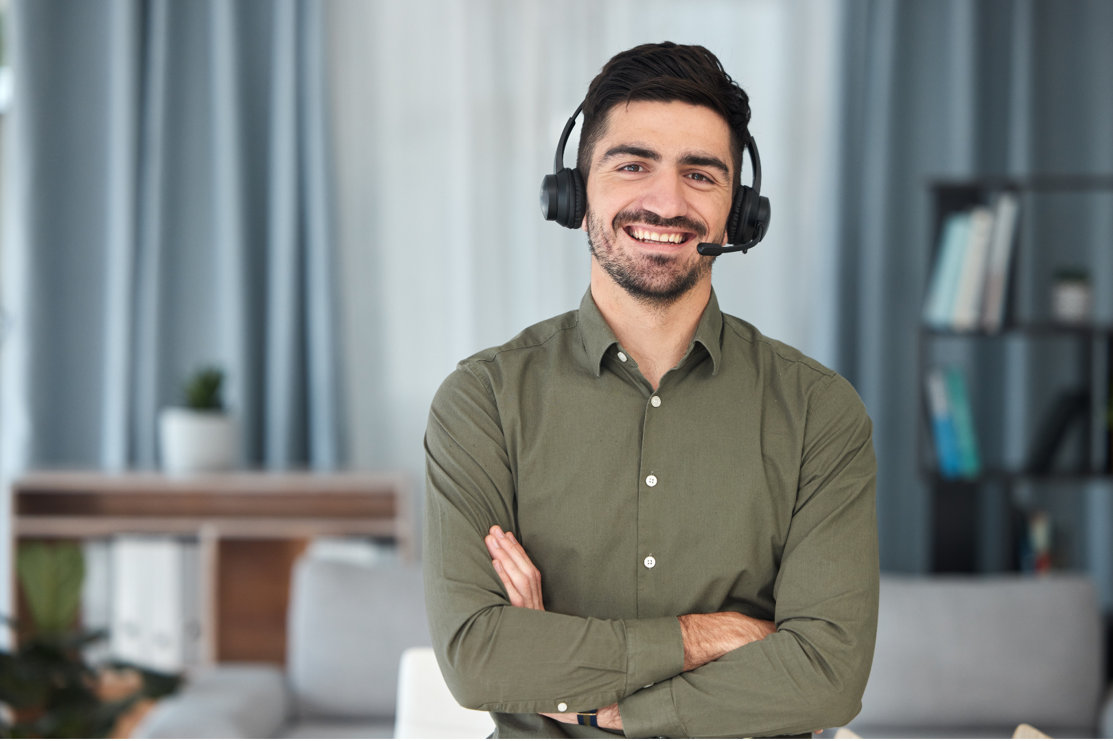 Smiling support representative wearing a headset in a modern office
