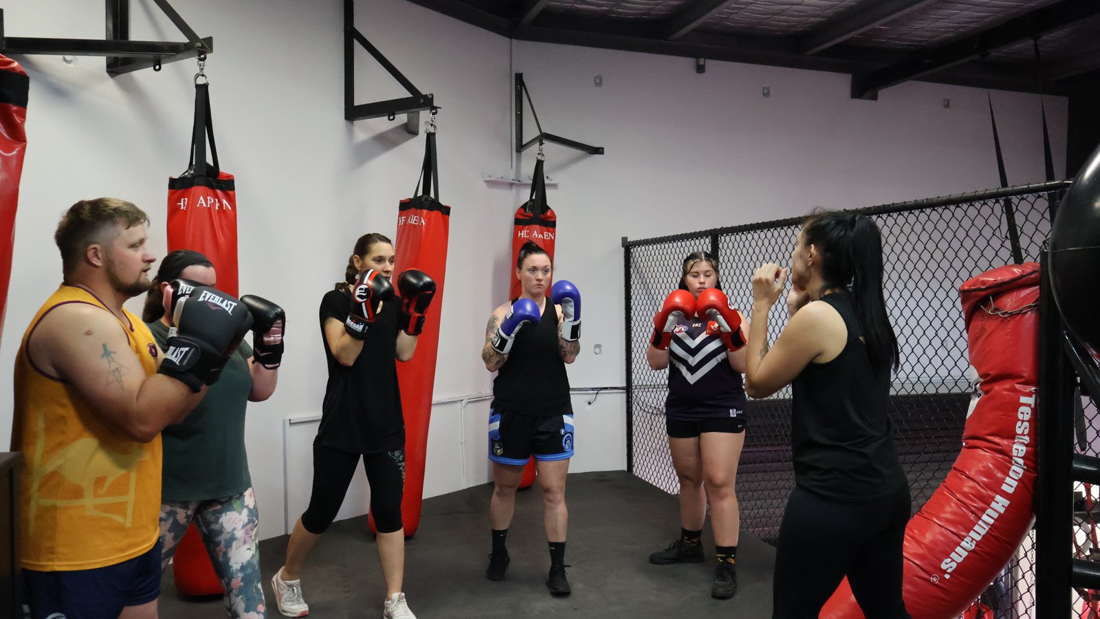 Adults training boxing on the bags at Roar MMA Rockingham, 2/4 Commodore Drive, Rockingham WA