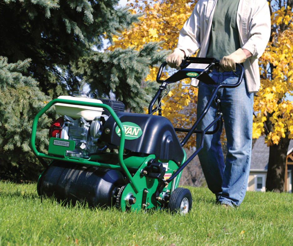Professional operating a walk-behind lawn aerator