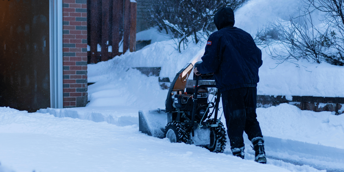Professional shoveling snow from a residential pathway