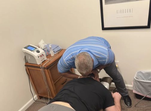 Dr. Gerdine treating a patient lying face down on the treatment table