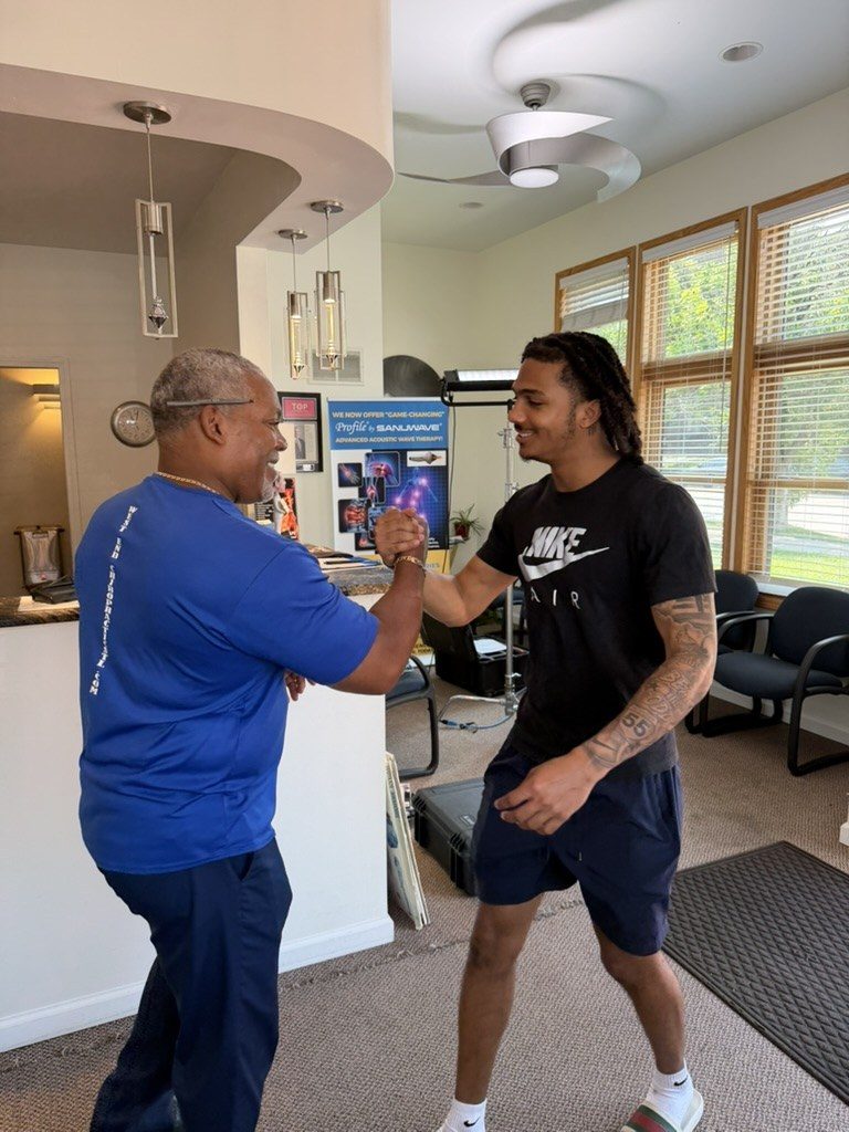 Dr. Gerdine greeting a college athlete in the clinic lobby