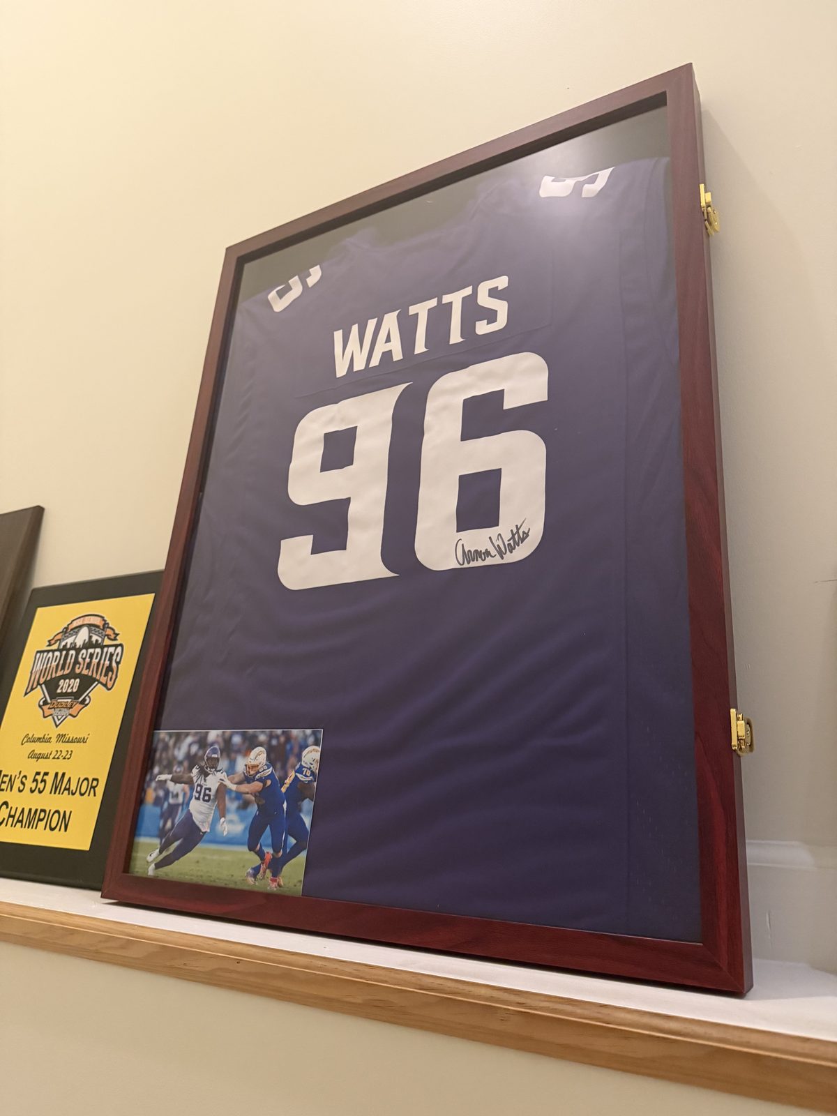 Framed autographed Watts number 96 jersey in the chiropractic office