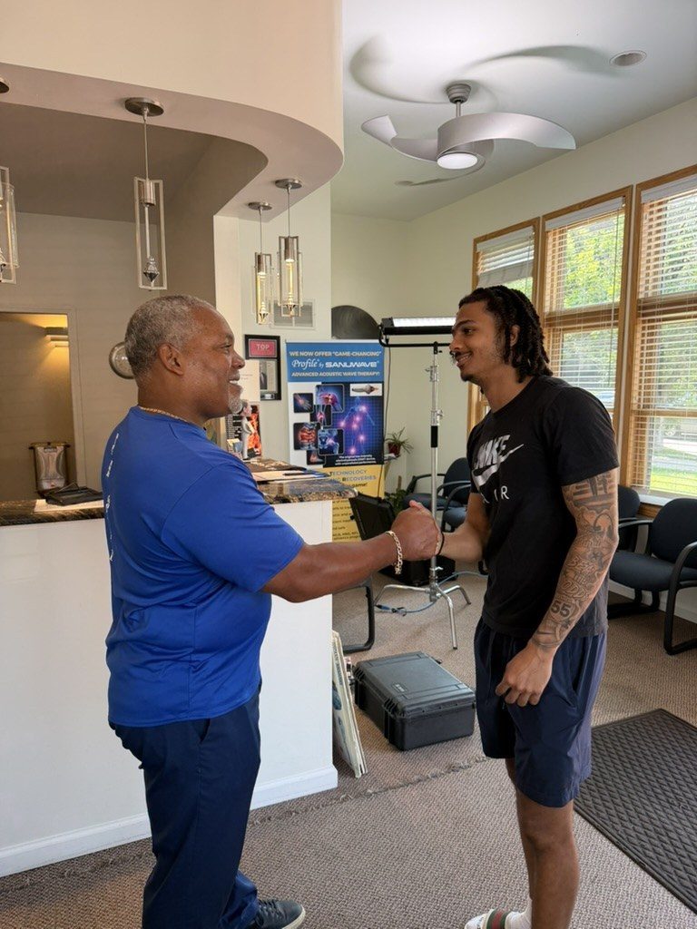 Dr. Gerdine shaking hands with a patient at the clinic's front desk