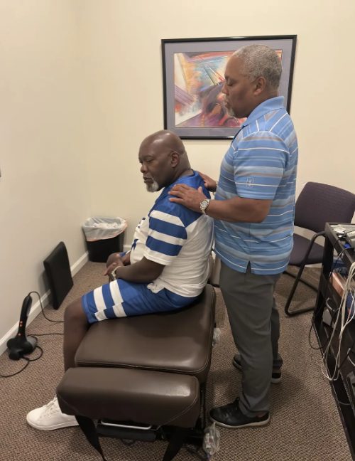 Dr. Gerdine treating the neck and shoulders of a seated patient