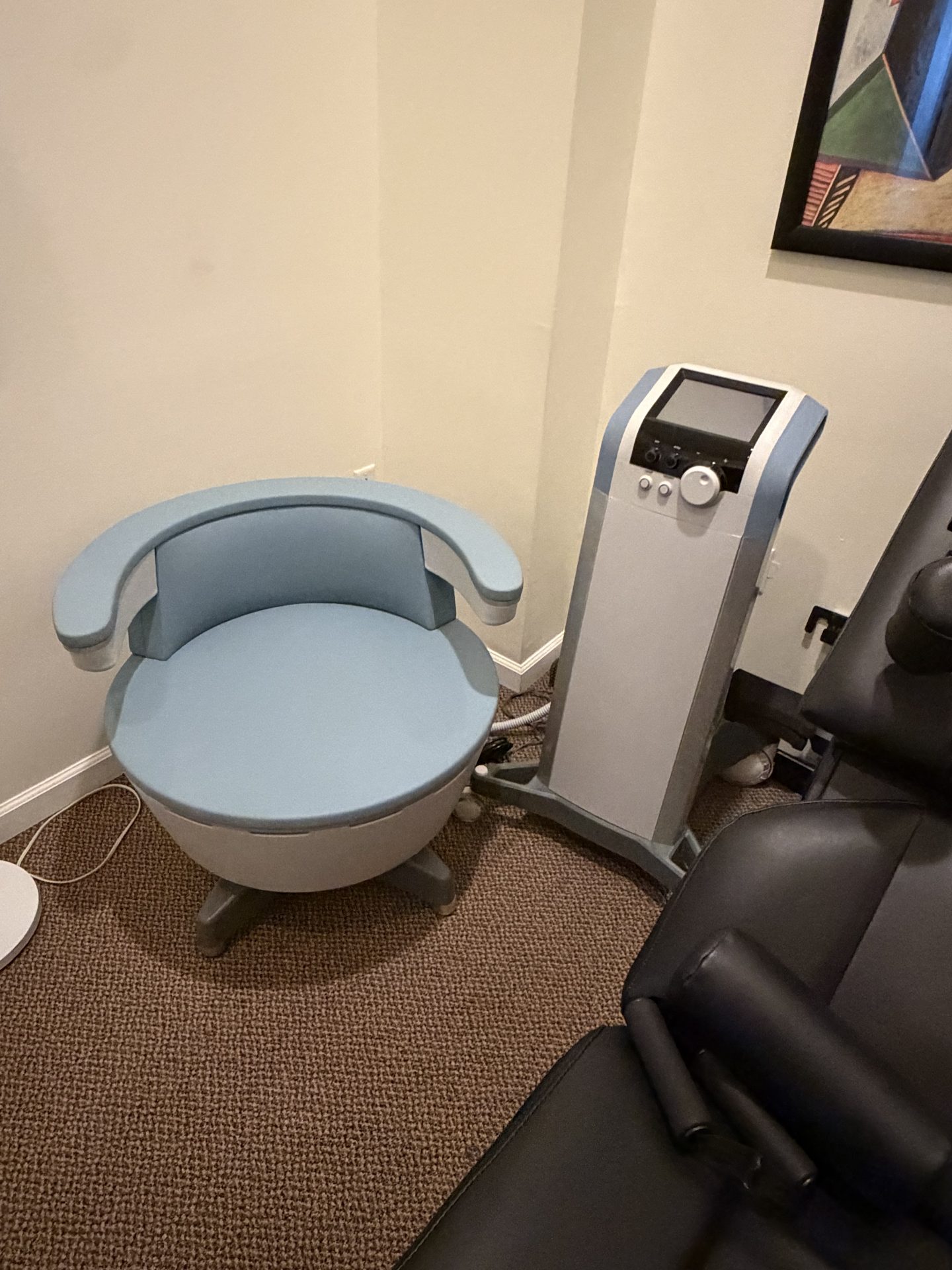 Electromagnetic pelvic floor strengthening chair and control unit in a private treatment room at West End Chiropractic in St. Louis