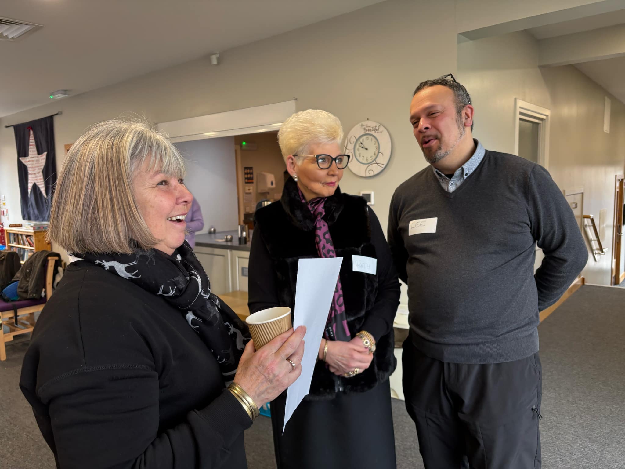 People sharing conversation at a church gathering