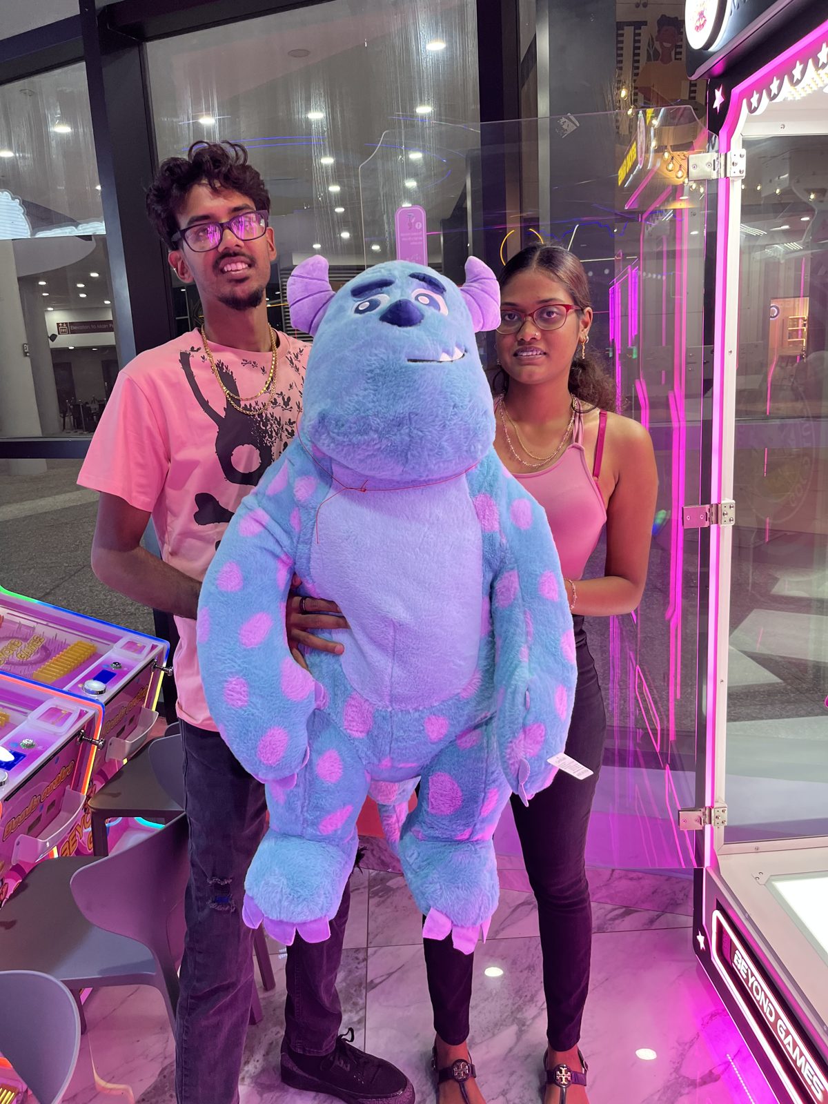 Guests with a costumed mascot at the arcade
