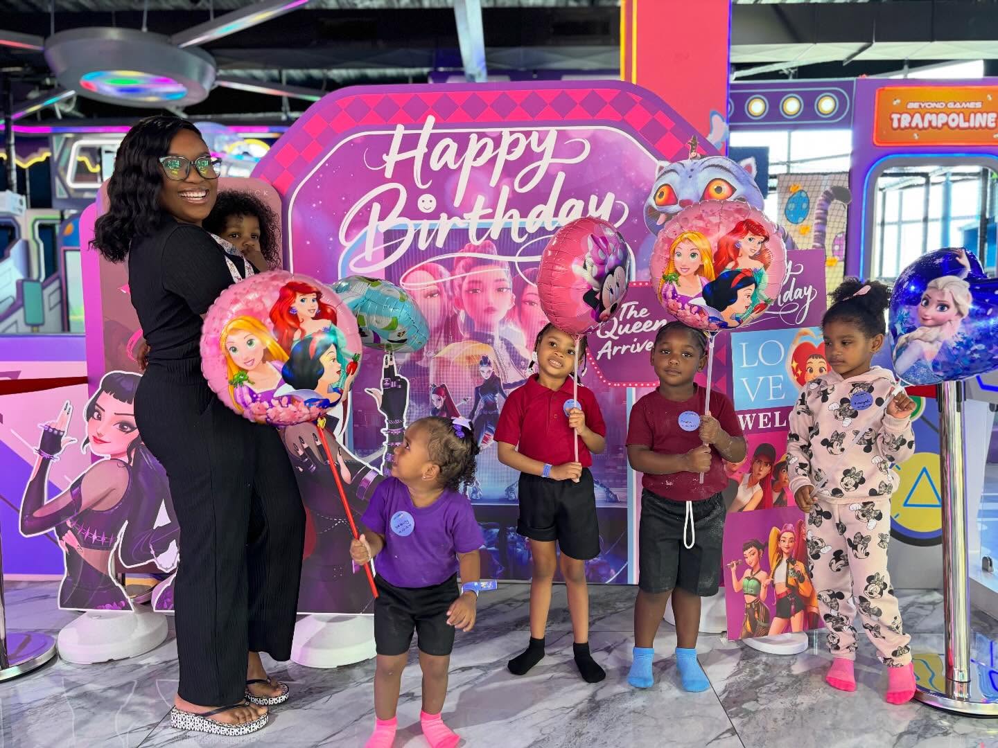 Kids celebrating a birthday with balloons