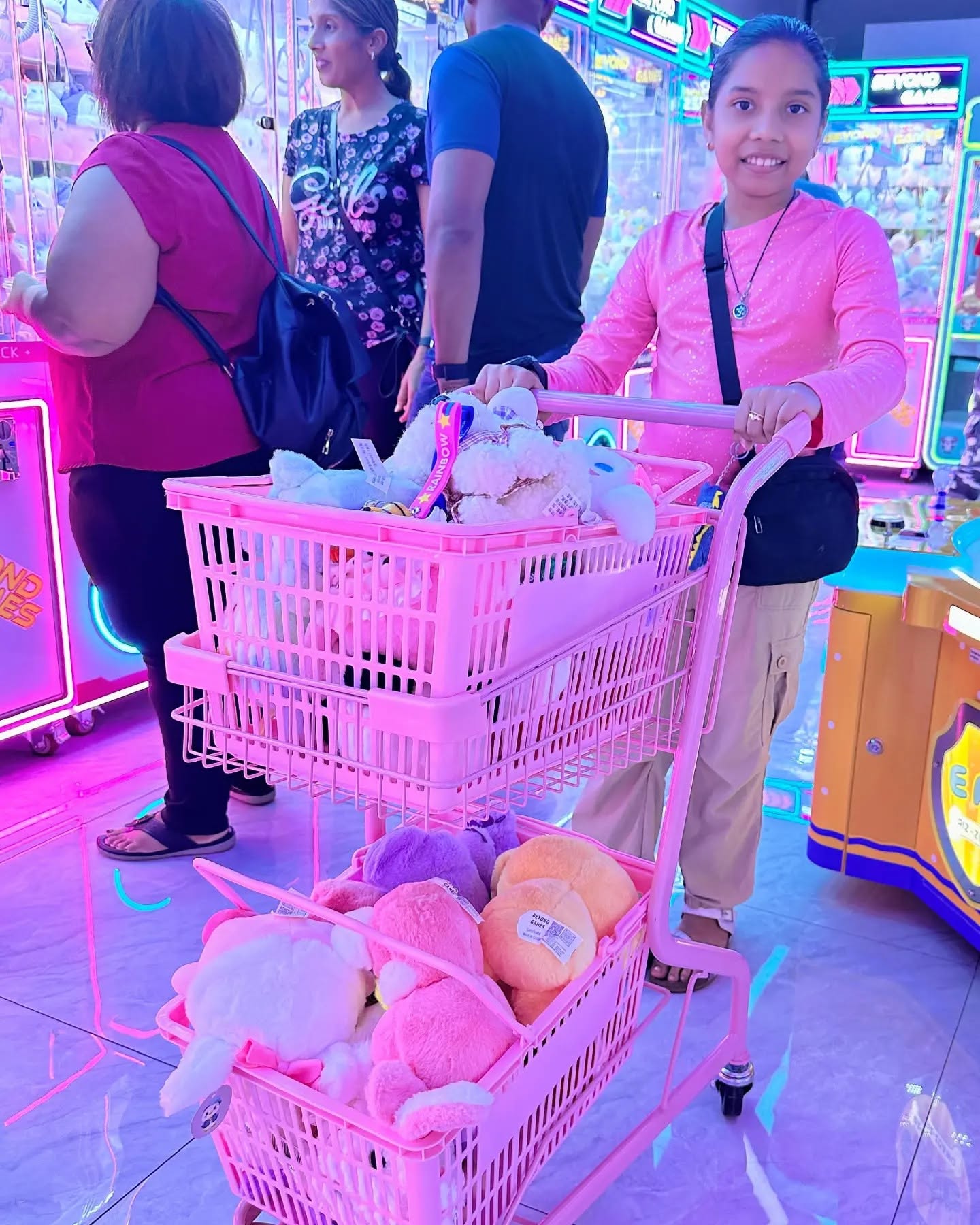 Girl with a cart full of plushie prizes