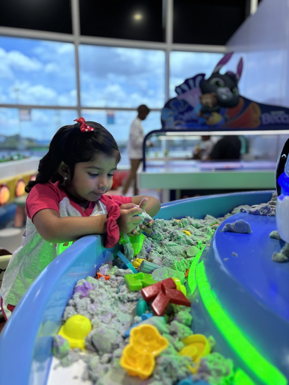 Girl playing at the sensory sand table