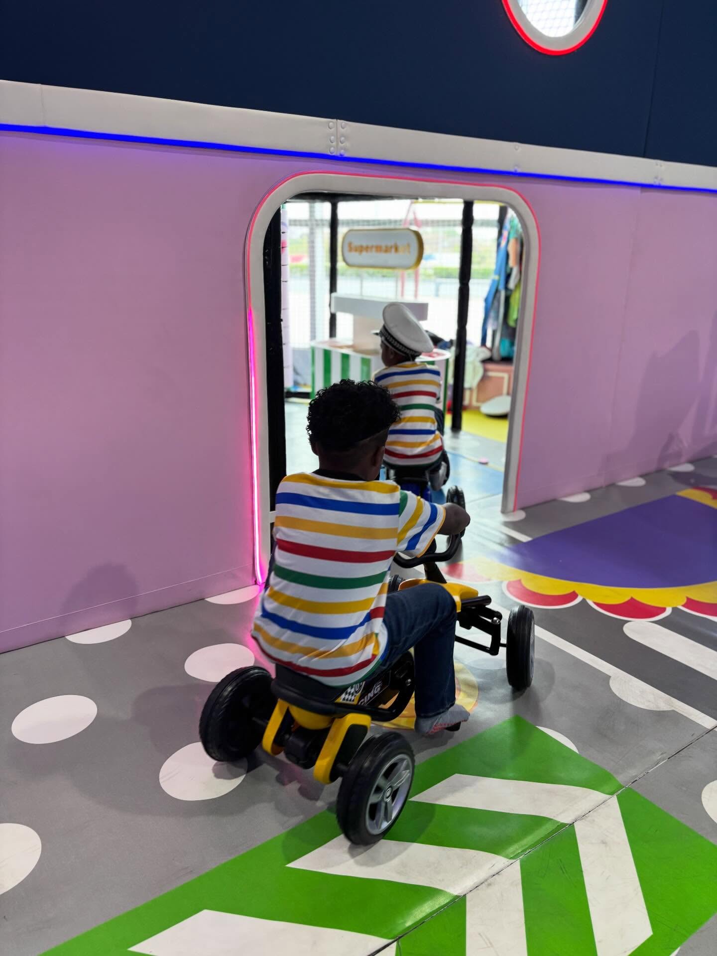 Kids on ride-on trikes in the role-play area