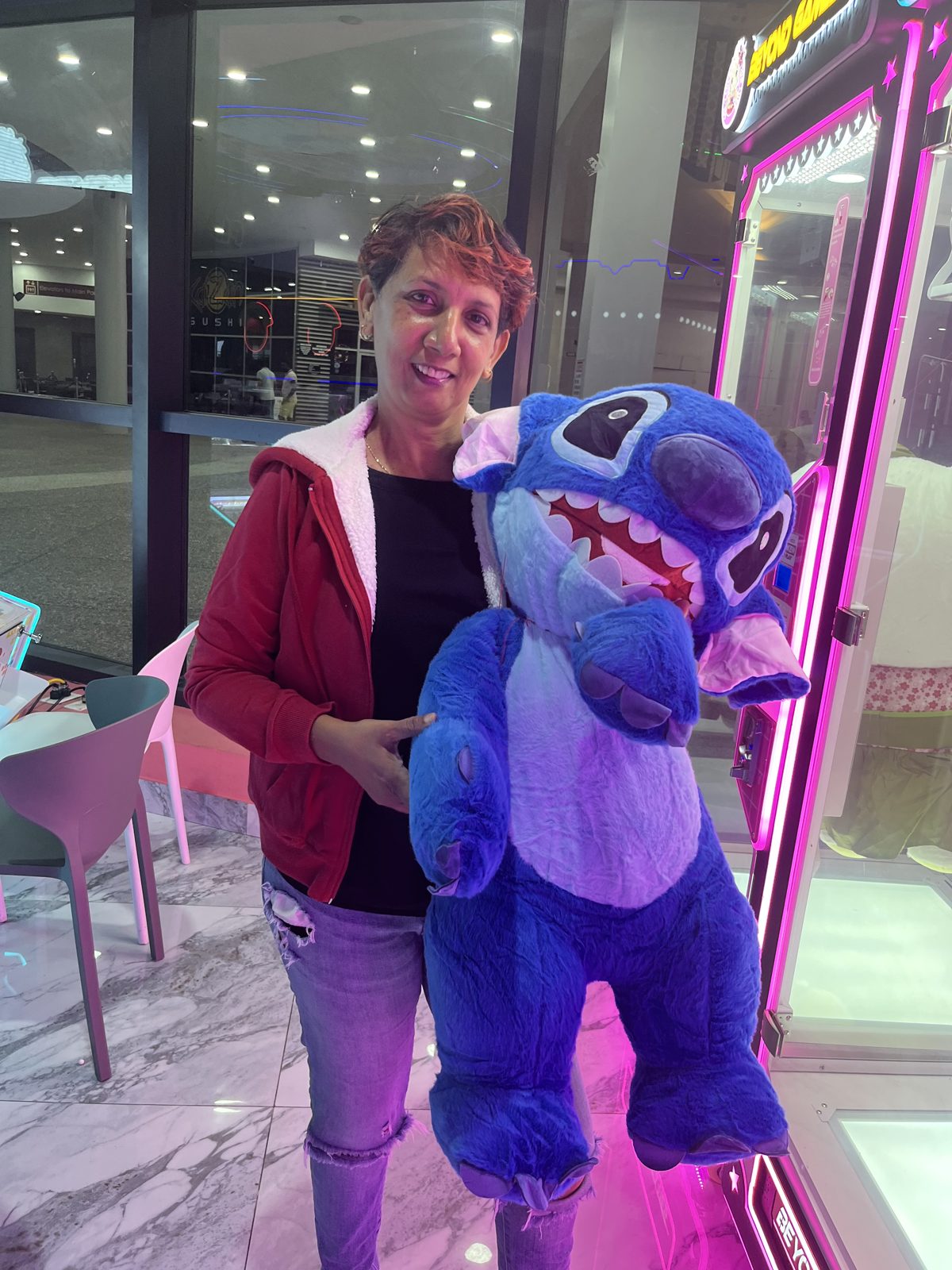 Guest hugging a Beyond Games costumed mascot