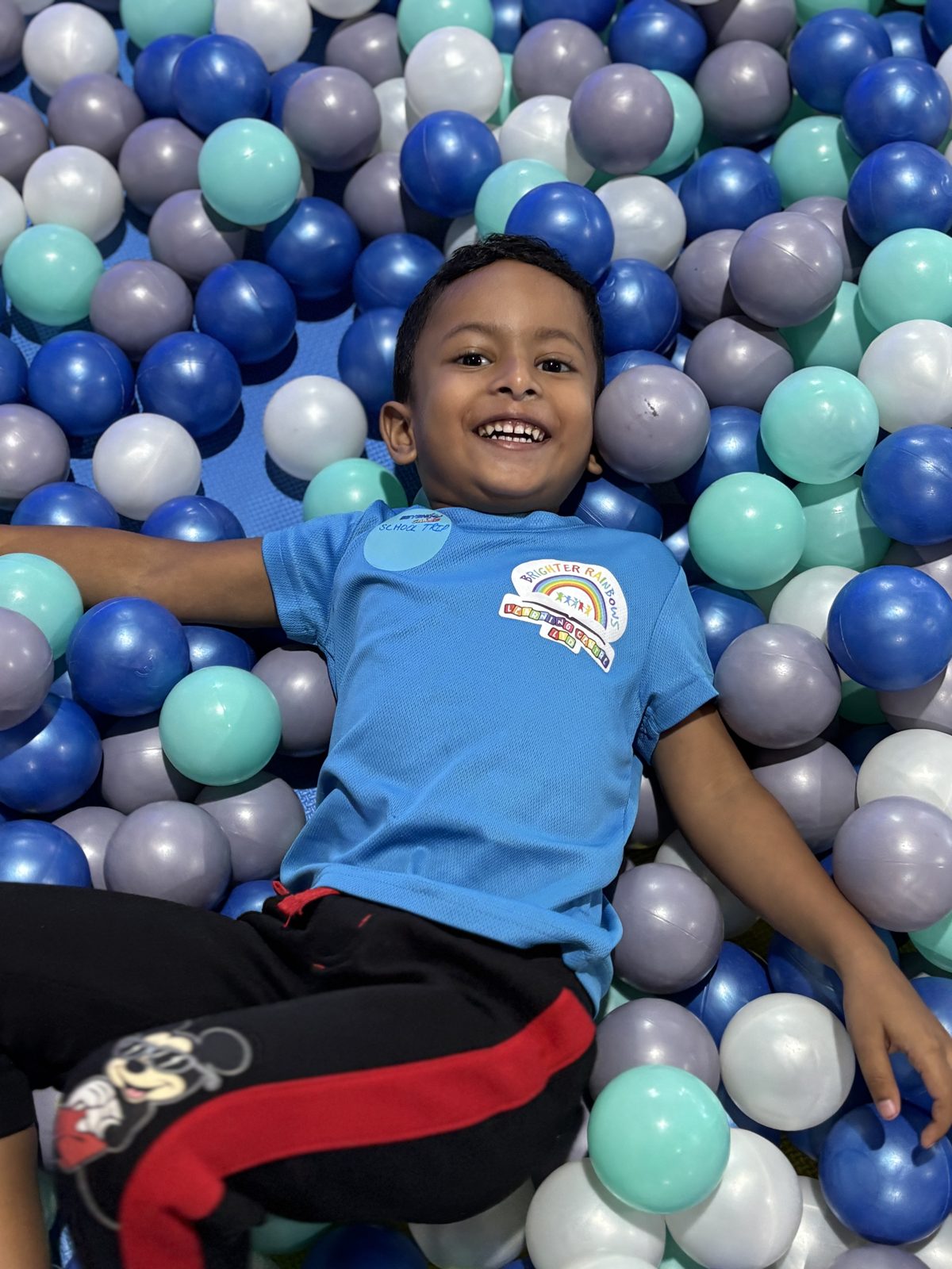 Boy relaxing in the ball pit