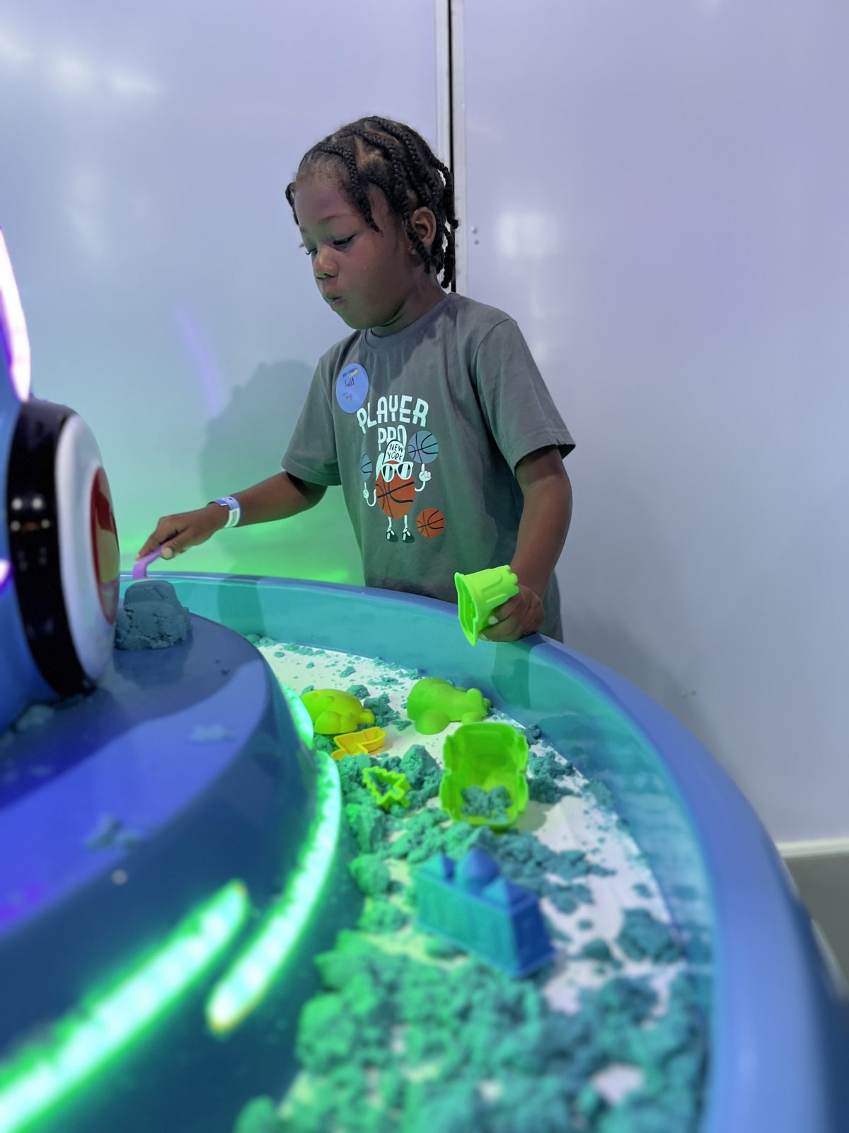 Boy at a glowing sensory play table