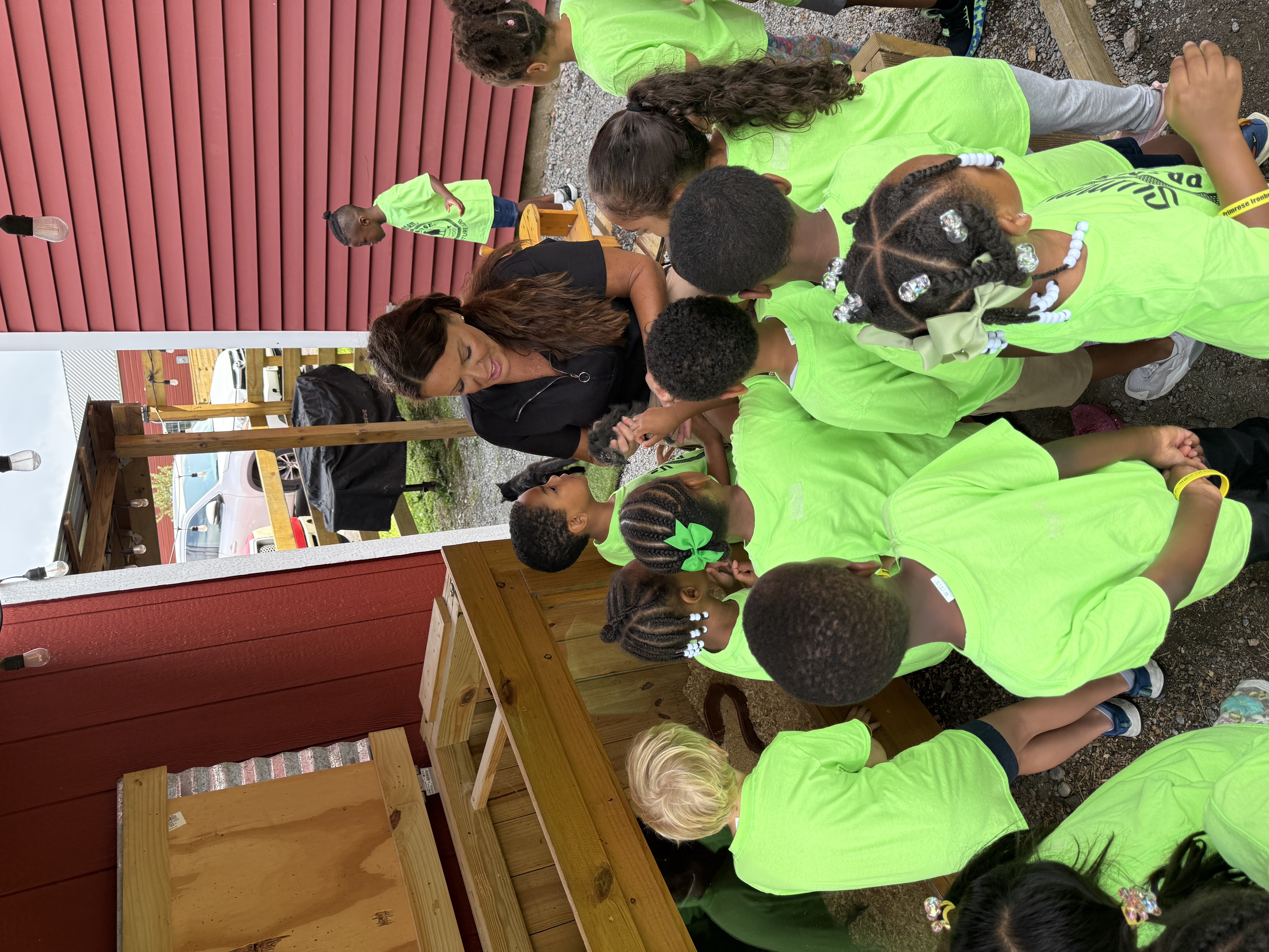 Teacher showing a chicken to a large group of students