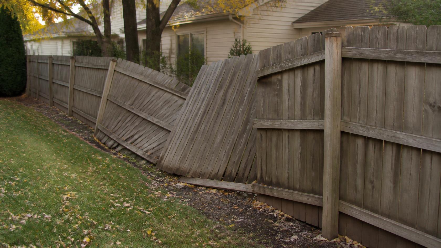 Residential fence in South Beloit, IL being inspected for wind damage to posts, panels, gates, and fence connections after fall storms.