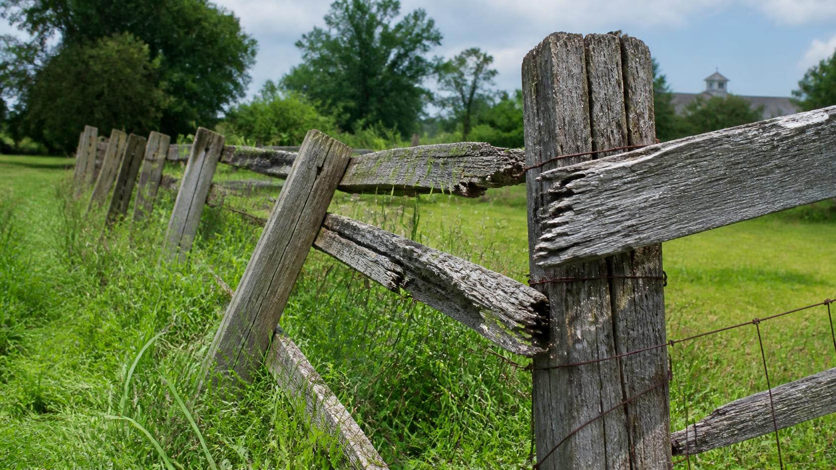 Fence posts in Oregon, IL being inspected for leaning, rot, shifting, damage, and other problems that may require repair.