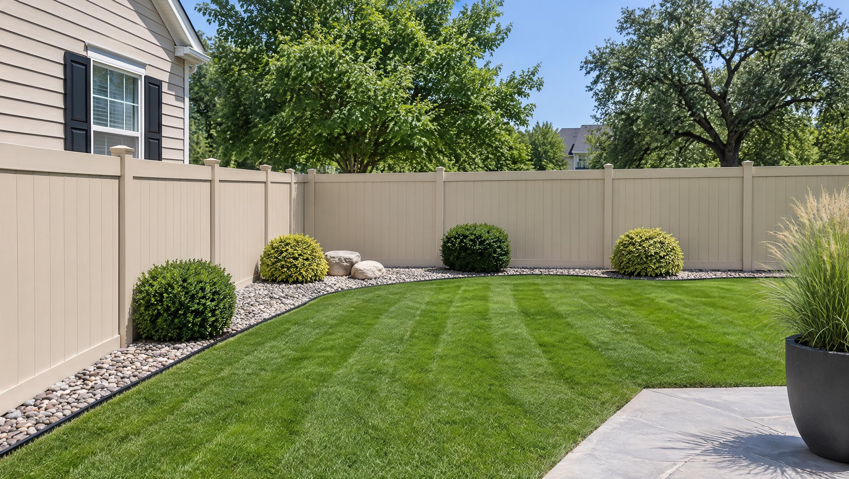 Residential backyard in Rockford, IL, featuring a clean white vinyl fence that provides privacy, defines the yard, and offers a low-maintenance fencing option.