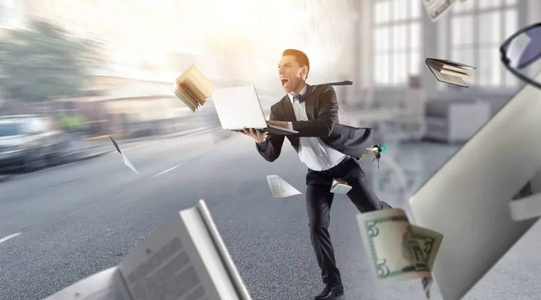 Businessman running through flying papers and money