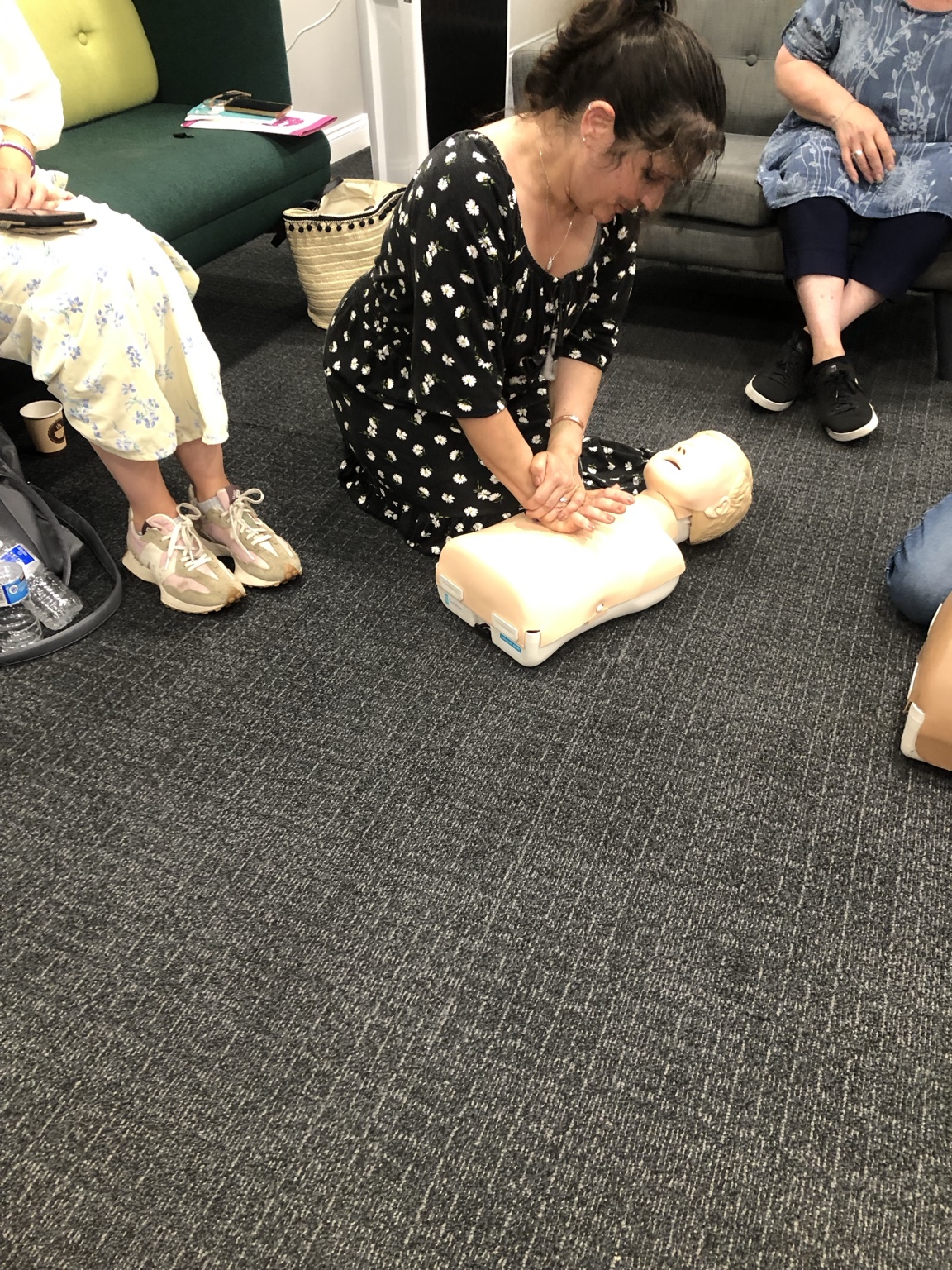 Hands-on first aid practice during a JACT Wellness training session