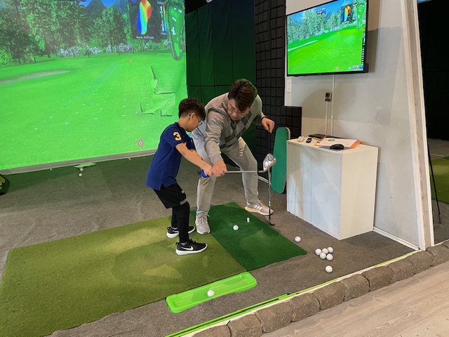 Junior golf coaching on Full Swing simulator