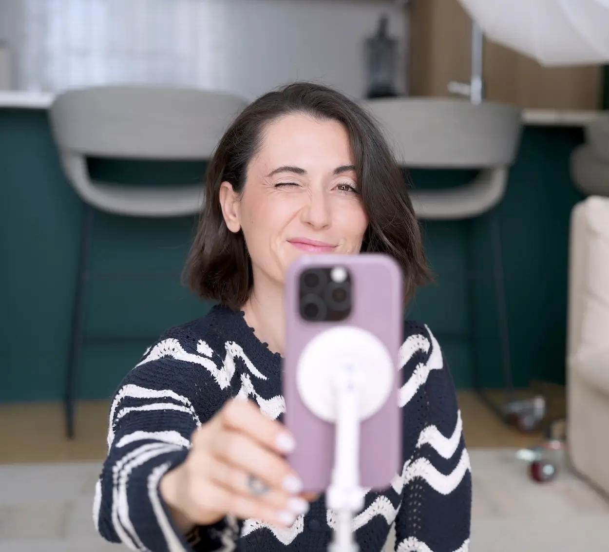 Alex winking as she hits record on iphone
