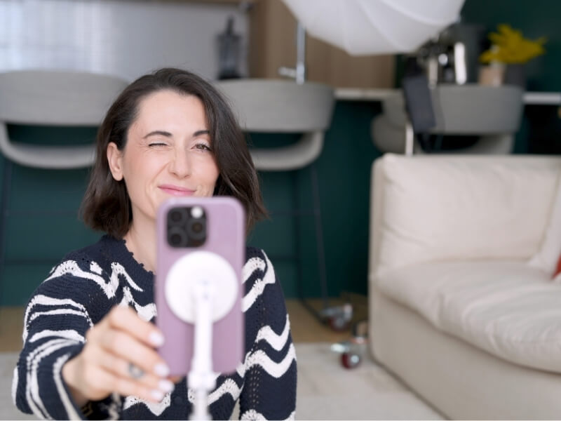 Alex winking as she hits record on iphone