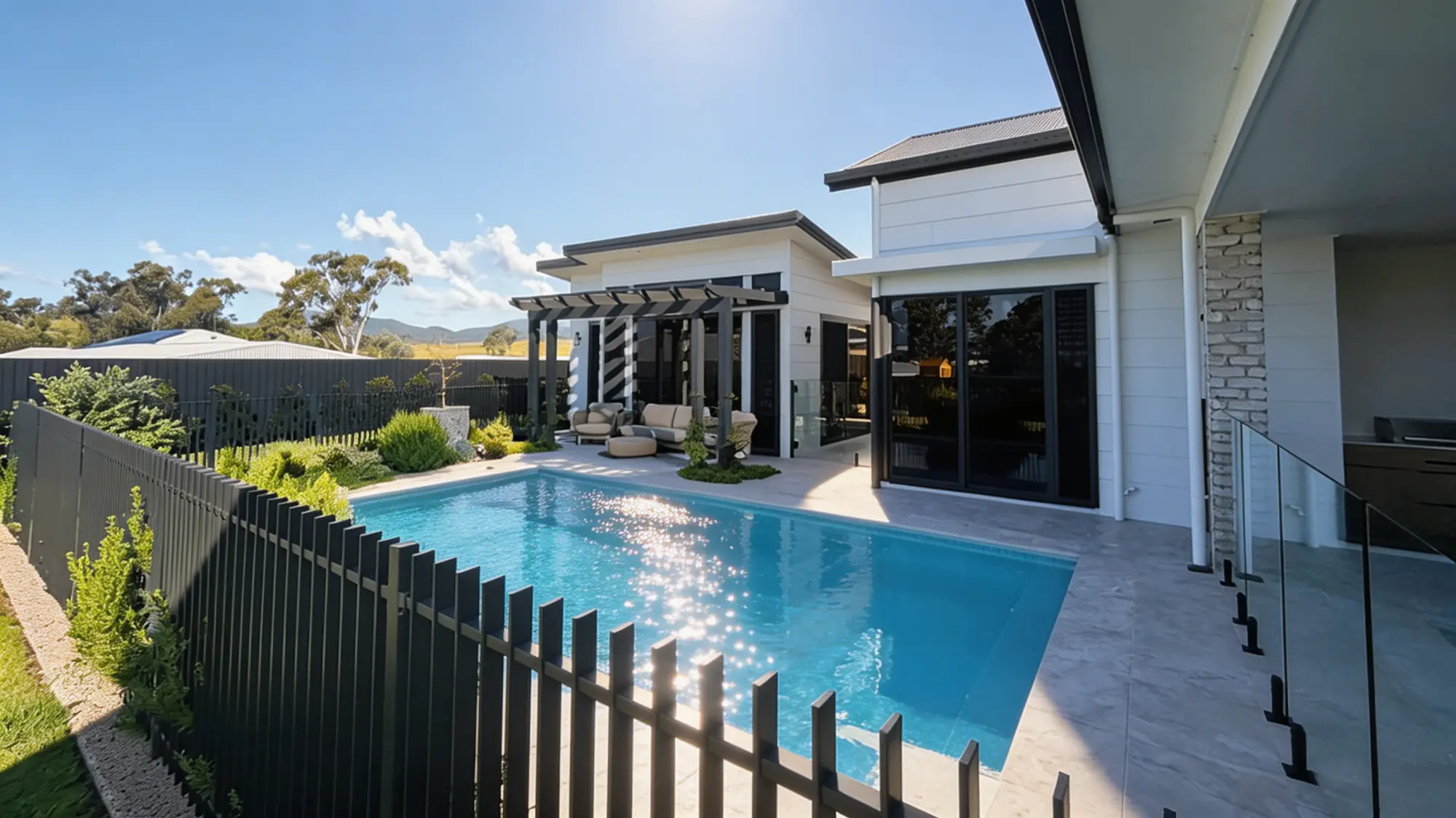 Wide view of the Courtyard Oasis pool, fencing and Parkhurst home