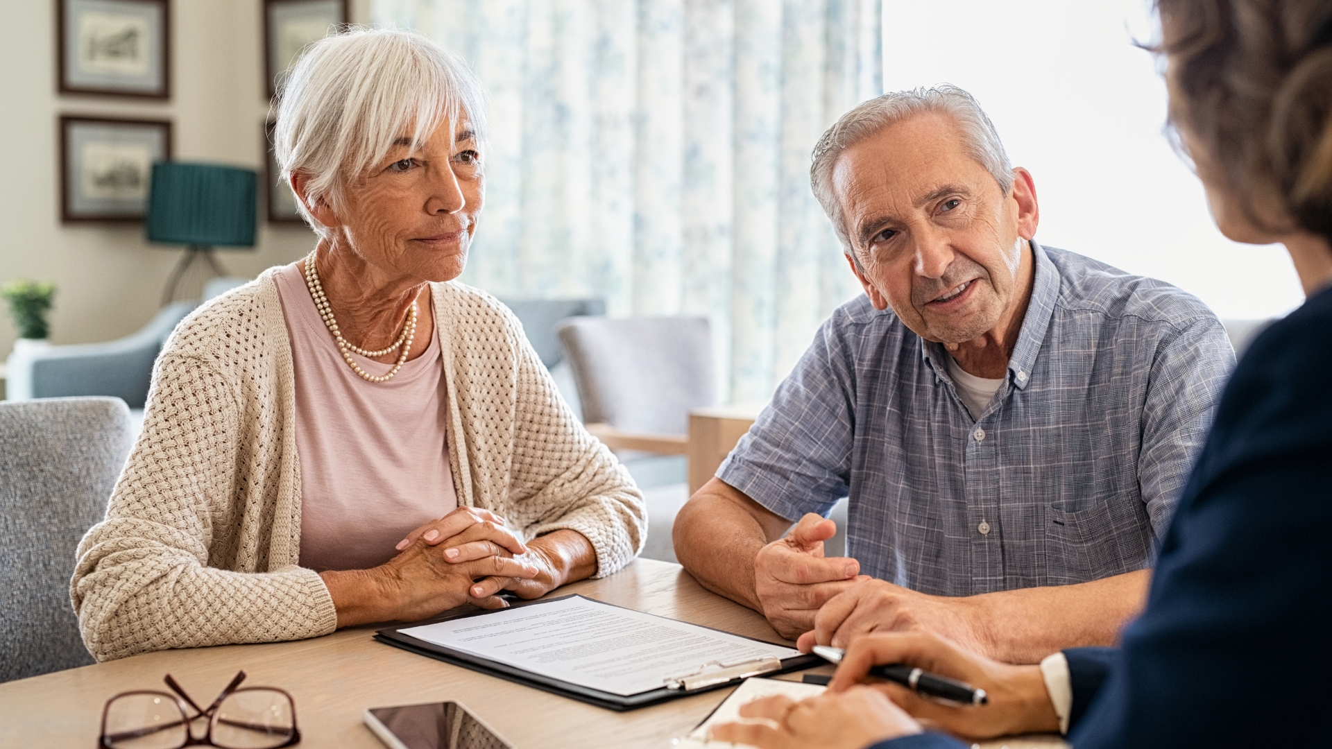 An older couple reviewing documents with an advisor