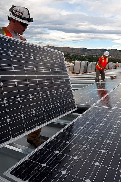 Workers installing solar panels