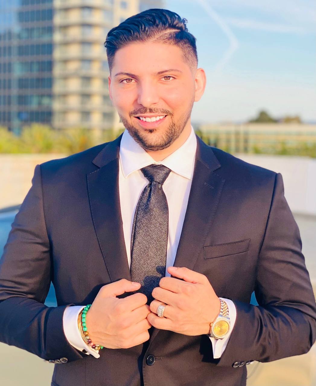 Ricky Andrade — founder and automation-focused operator, professional portrait with city skyline