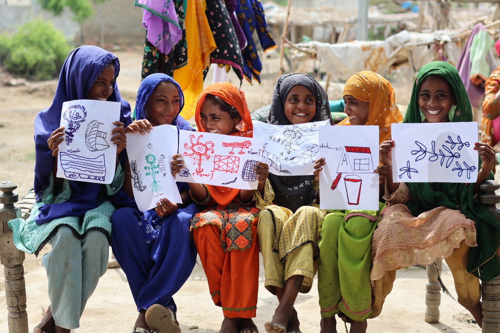 Girls sharing drawings in Pakistan