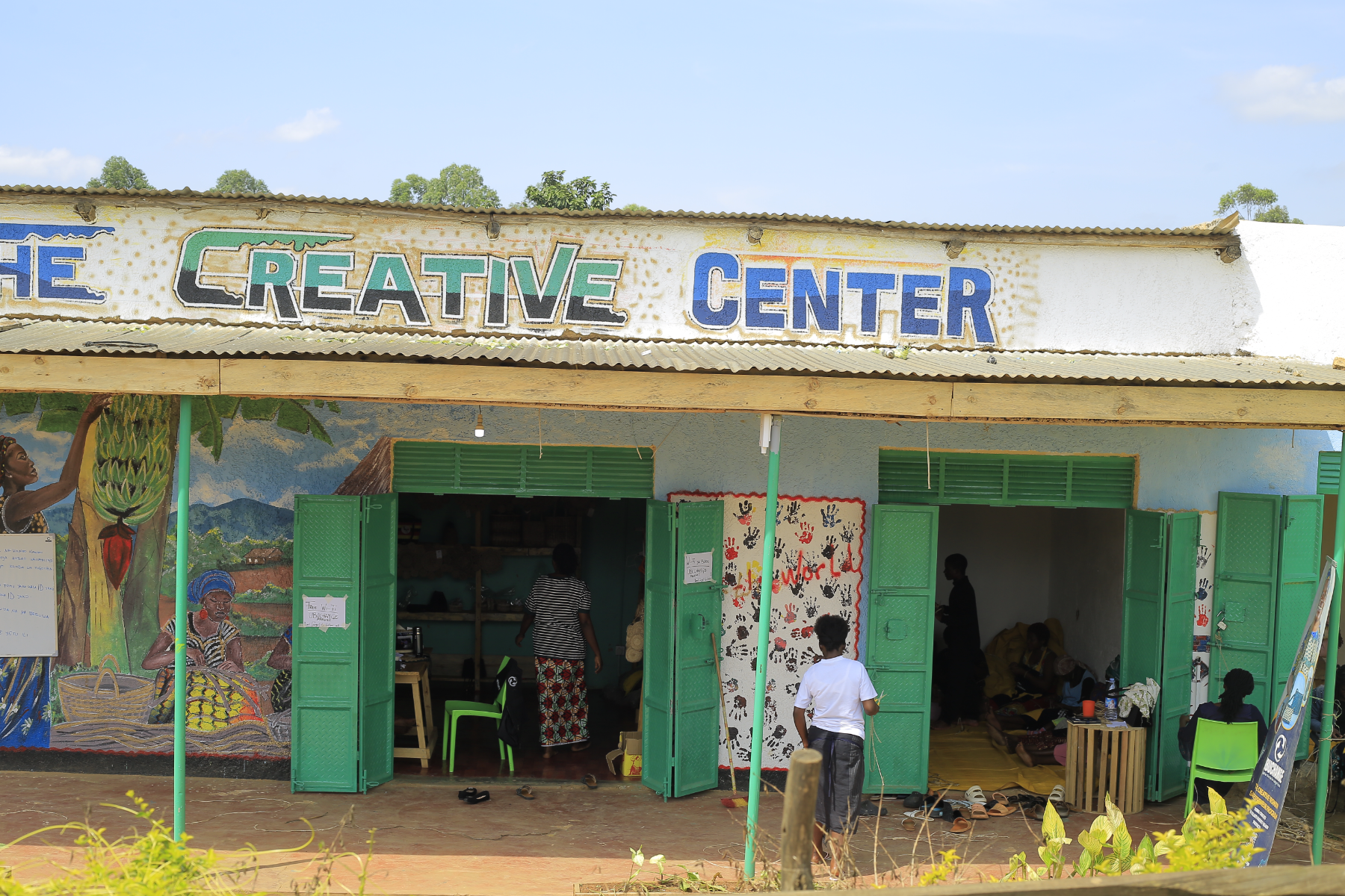 The painted front of the UBUCHANGE Creative Center with green doors open