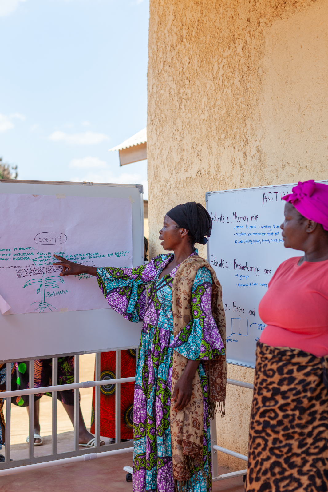 A woman presents her group’s plan at the design session