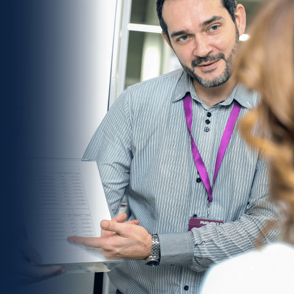 Engineers reviewing motorized screen structural data and load analysis for wind load calculations, seismic ratings, and validation of design requirements