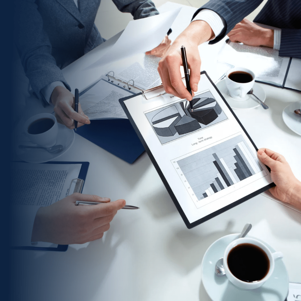 Engineering team collaborating on system design and planning for motorized screens, reviewing structural integration and operational specification charts