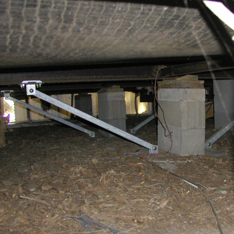 A set of newly installed, rust-resistant mobile home tie-downs securing a home in Lakeland for hurricane season.