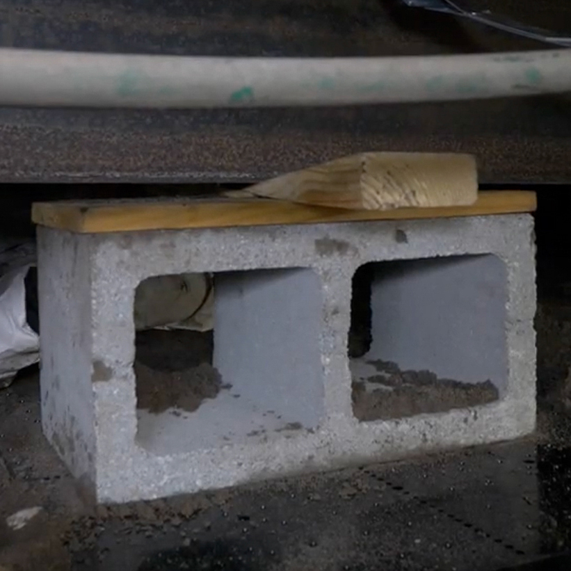 The Vapor Barrier Naples team using concrete blocks to re-level a manufactured home in Naples, Florida.