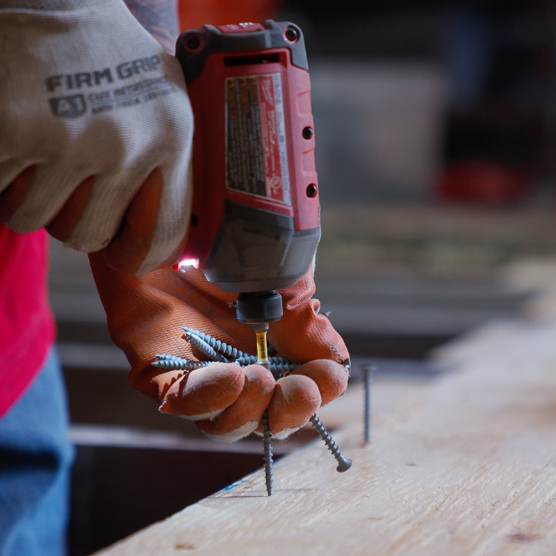 A professional from our team carefully sealing the seams of a new vapor barrier installation in a Naples mobile home